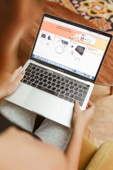 A modern computer screen displaying web design work, showcasing creative visuals in a workspace.